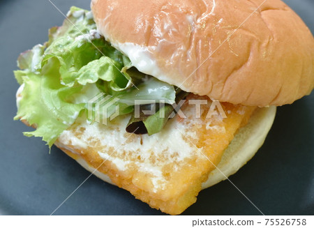 fried fish cheese hamburger with mayonnaise sauce and lettuce on plate 75526758