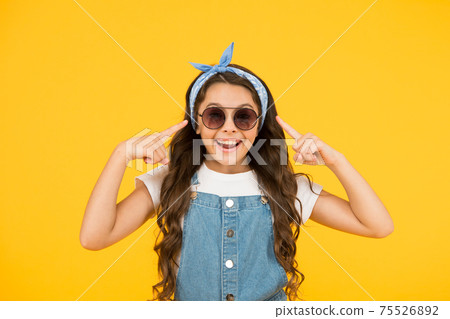 UV protection. Girl long curly hair sunglasses tied head  75526892