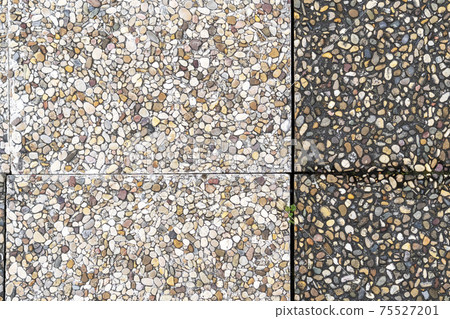 Pebble stone in outdoor tiles with geometric shapes. Close-up. Copy space 75527201