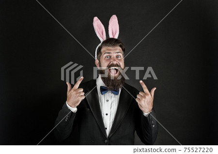Easter idea. Happy manager pointing fingers up. Bearded 75527220