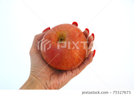 Witch's hand holding a poisoned apple 75527673