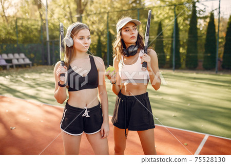 Beautiful and stylish girls on the tennis court 75528130