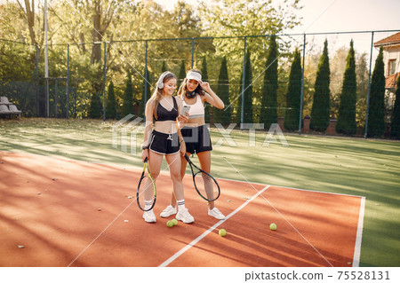 Beautiful and stylish girls on the tennis court 75528131