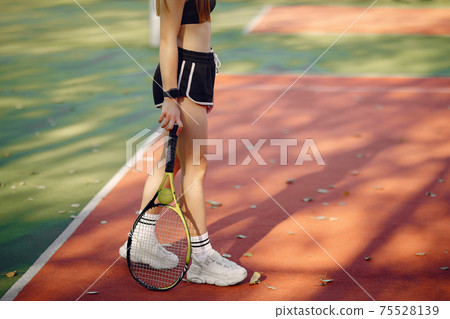 Beautiful and stylish girl on the tennis court Beautiful and stylish girl on the tennis court 75528139