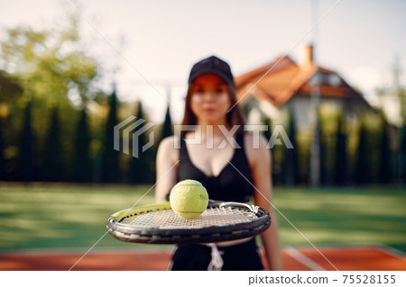 Beautiful and stylish girl on the tennis court Beautiful and stylish girl on the tennis court 75528155