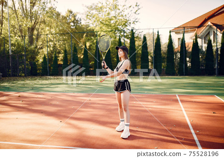 Beautiful and stylish girl on the tennis court Beautiful and stylish girl on the tennis court 75528196