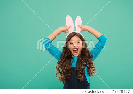 Play with ears. Preparing for Easter holiday. Small girl Play with ears. Preparing for Easter holiday. Small girl 75528197