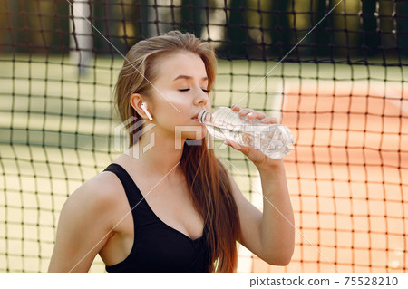 Beautiful and stylish girl on the tennis court Beautiful and stylish girl on the tennis court 75528210