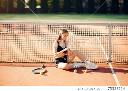 Beautiful and stylish girl on the tennis court Beautiful and stylish girl on the tennis court 75528214