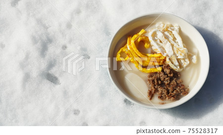 Delicious rice cake soup with winter snow in the background Delicious rice cake soup with winter snow in the background 75528317