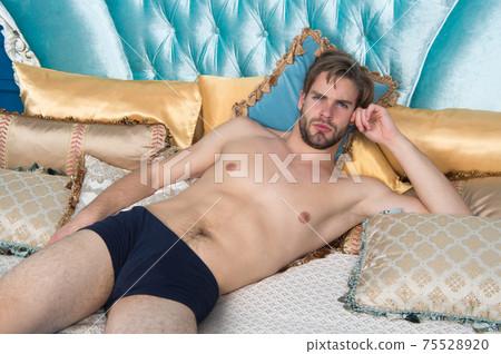 Handsome and sleepy. Enjoying single life. Sexy man lying 75528920