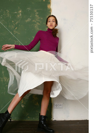 teenager girl ballet dancer in skirt and boots dancing on green wall background teenager girl ballet dancer in skirt and boots dancing on green wall background 75530137