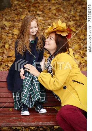 Irish little girl with mom outdoor photo on fall landscape background Irish little girl with mom outdoor photo on fall landscape background 75530146