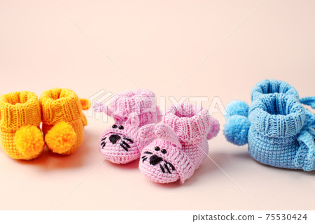Set three Pairs of baby booties, shoes on pastel, cozy conceptual idea. Guess gender of the child, baby shower party. Preparation and choice of color for newborn baby room, mom mother day Set three Pairs of baby booties, shoes on pastel, cozy conceptual idea. Guess gender of the child, baby shower party. Preparation and choice of color for newborn baby room, mom mother day 75530424