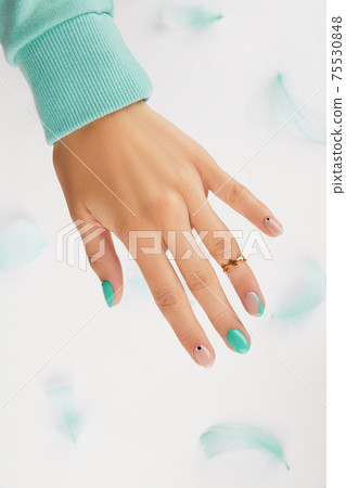 Womans hand with trendy turquoise manicure with copy space 75530848
