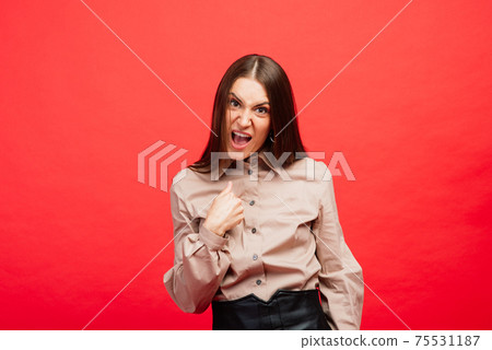 The young emotional angry, scared woman looking at camera.The human emotions, facial expression concept. The young emotional angry, scared woman looking at camera.The human emotions, facial expression concept. 75531187