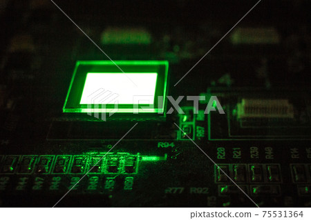 The process of checking several oled displays on the test station. Displays glow brightly of green color close up. The process of checking several oled displays on the test station. Displays glow brightly of green color close up. 75531364