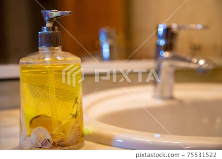 yellow liquid soap, faucet and bathroom mirror yellow liquid soap, faucet and bathroom mirror 75531522