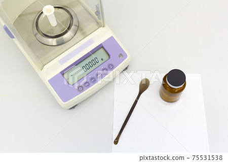 laboratory scale on table with materials in bottles. laboratory scale on table with materials in bottles. 75531538