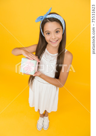 Little gift. Happy girl hold gift box. Small child smile Little gift. Happy girl hold gift box. Small child smile 75531623