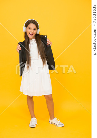 Cherishing inner rocker. Listening music. Girl with headphones. Cherishing inner rocker. Listening music. Girl with headphones. 75531638