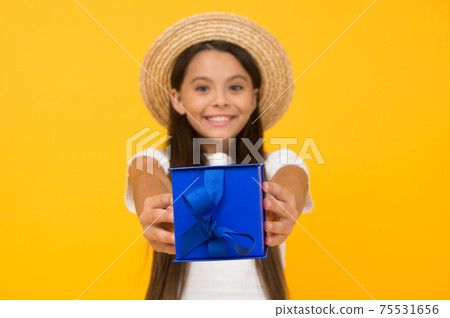 Gift wrapped decorated box in hands of cute child girl, birthday surprise concept Gift wrapped decorated box in hands of cute child girl, birthday surprise concept 75531656