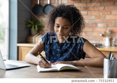 Interested black teen female watch video lesson write in copybook Interested black teen female watch video lesson write in copybook 75532951