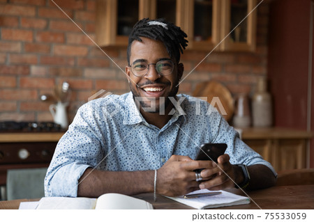 Portrait of successful black male modern day student holding smartphone Portrait of successful black male modern day student holding smartphone 75533059