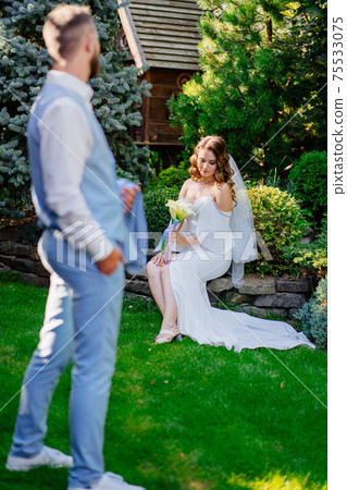 selective focus. newlyweds in the summer garden. wedding photo shoot in the park 75533075