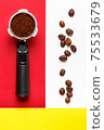 Espresso machine filter with ground coffee and coffee beans. 75533679