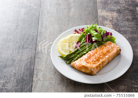 Grilled salmon fillet with asparagus and salad Grilled salmon fillet with asparagus and salad 75533866