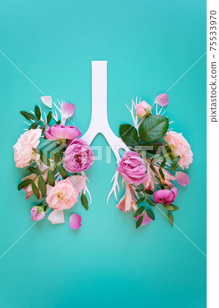 Medical concept of pink lilac flowers shaped in human lungs on blue background. Inflammation of the lungs concept, viral epidemic. 75533970