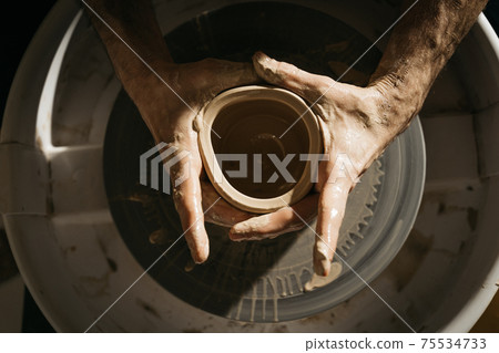 Top view of the master ceramist working at his studio Top view of the master ceramist working at his studio 75534733