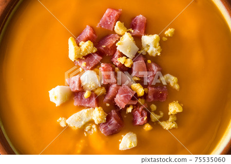 Typical Spanish salmorejo cream with ham and egg on wooden table Typical Spanish salmorejo cream with ham and egg on wooden table 75535060