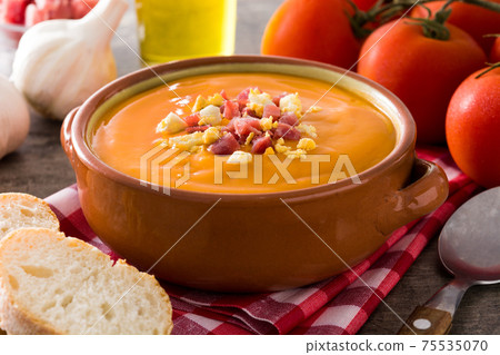Typical Spanish salmorejo cream with ham and egg on wooden table Typical Spanish salmorejo cream with ham and egg on wooden table 75535070