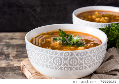 Harira soup in bowl on wooden table. Typical Moroccan food. Ramadan concept. 75535083