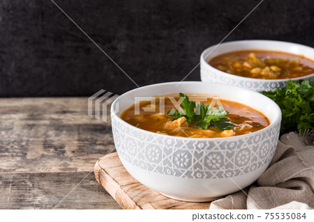Harira soup in bowl on wooden table. Typical Moroccan food. Ramadan concept. 75535084