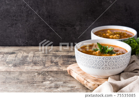 Harira soup in bowl on wooden table. Typical Moroccan food. Ramadan concept. Harira soup in bowl on wooden table. Typical Moroccan food. Ramadan concept. 75535085