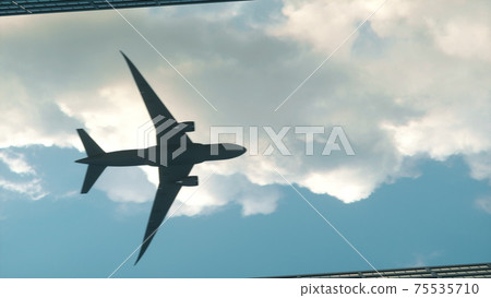 Airplane flying over the top big city skyscraper office buildings. 3d rendering Airplane flying over the top big city skyscraper office buildings. 3d rendering 75535710
