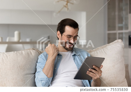 Happy man use tablet win online lottery Happy man use tablet win online lottery 75535830