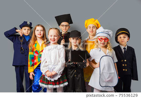 Group of school children dressing up as professions 75536129