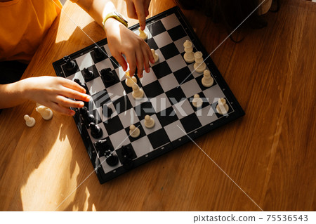 Top view boy and girl playing chess Top view boy and girl playing chess 75536543