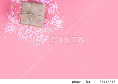 Gift box with brown Kraft paper surrounded with pink daisies and flatlay pink background, spring, Happy Mothers Day, Valentines Day and other Holliday concept top view, Modern design Gift box with brown Kraft paper surrounded with pink daisies and flatlay pink background, spring, Happy Mothers Day, Valentines Day and other Holliday concept top view, Modern design 75537247