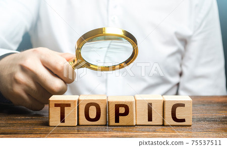 Man examines blocks with topic with a magnifying glass. Conduct research, get an topic explanation. Become an expert, understand the case. Understanding the subject. Assessing value of information 75537511