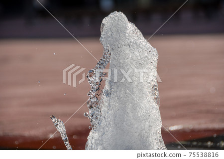 A small fountain on the street corner in early summer A small fountain on the street corner in early summer 75538816