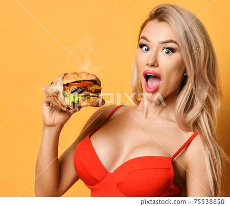 Woman hold big cheeseburger burger sandwich with 75538850