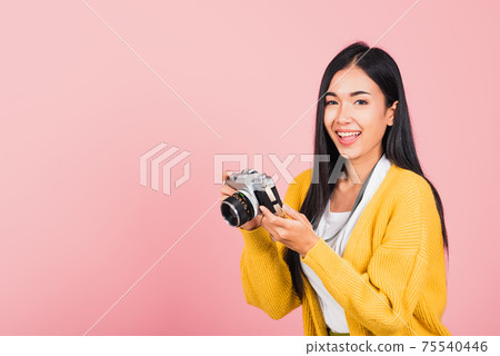 woman teen excited smiling holding vintage photo camera woman teen excited smiling holding vintage photo camera 75540446