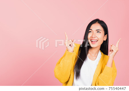 woman standing makes gesture two fingers point upwards above presenting product something woman standing makes gesture two fingers point upwards above presenting product something 75540447