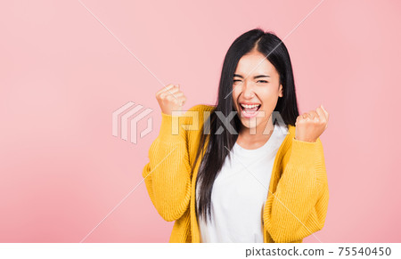 woman standing winning and surprised excited screaming woman standing winning and surprised excited screaming 75540450