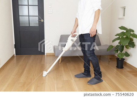 A male sucking a vacuum cleaner A male sucking a vacuum cleaner 75540620